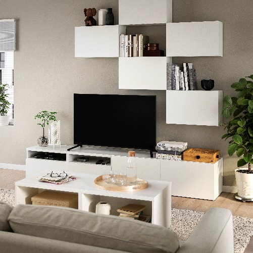 A living room with a tv and shelves Description automatically generated